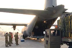 An RAAF C-130J Hercules is loaded with emergency aid for IDPs on Mt Sinjar in Iraq