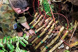 20 EOD Squadron techs wire up WW2 era Australian 2 Inch mortar shells at Torokina on Bougainville