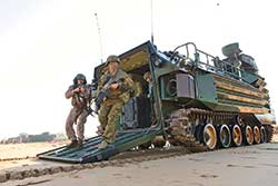 Aussie Diggers from the Bravo Coy 2RAR Amphibious Ready Element storm ashore from USMC AAV-7PA1 assault vehicles at Fog Bay during Talisman Sabre 15.